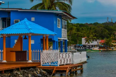 Bright blue stilt building over the water at Isla Grande, Colón