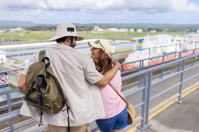 Visitors looking across the Panama Canal from an observation deck
