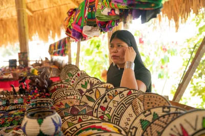 Emberá craft market with woven baskets, beadwork, and textiles