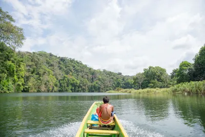 Canoe approaching the Emberá village through the rainforest river