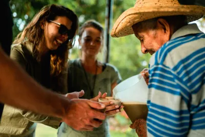 Visitors learning about traditional sugarcane juice at Trapiche Don Evelio