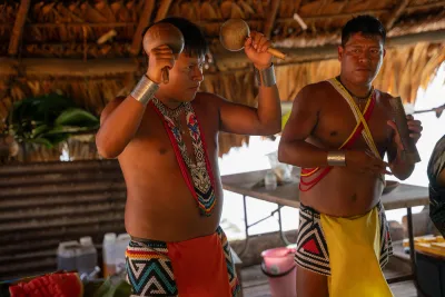Emberá musicians playing maracas during the village visit