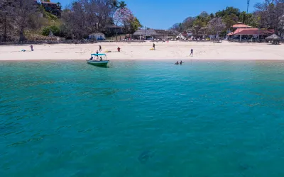 Boat floating in calm water at Cacique Beach on Contadora Island