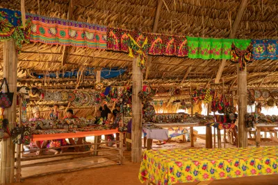Colorful craft displays inside the Emberá village bohio