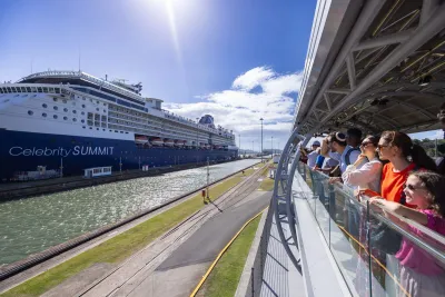 Visitors watching a cruise ship pass through Miraflores Locks at the Panama Canal