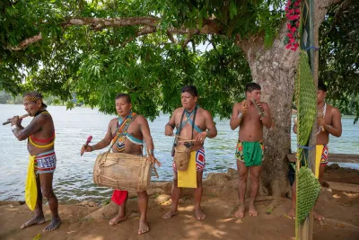 Emberá musicians performing by the riverbank